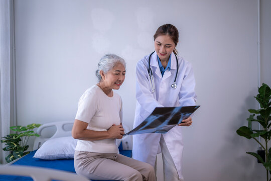 Doctor explaining x-ray to senior patient in clinic