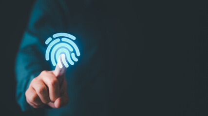 Businessman touching glowing fingerprint icon for biometric authentication and cyber security...