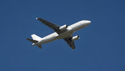 Low angle view of white commercial airplane flying in dark blue sky. Underneath view of jet aircraft in flight. Concept of air transportation, logistics, and global aviation industry.