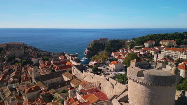 Aerial flypast of Minceta Tower towards Fort Lovrijenac. 4K drone footage of medieval fortress walls in Dubrovnik.