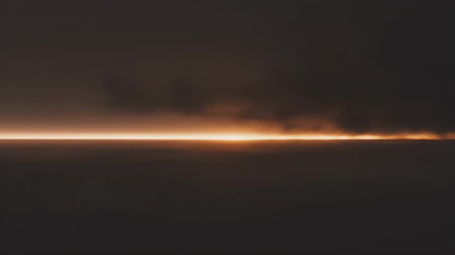 Horizon line of smoke and orange light, dark sky, subdued landscape