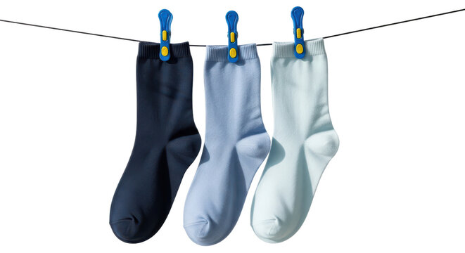 Three socks hanging on a clothesline with clips on a transparent background