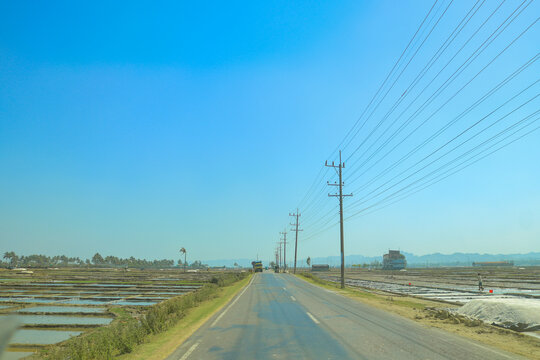 Scenic Coastal Road Near Salt Fields in Coxs Bazar Bangladesh