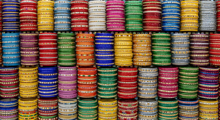 Colorful Indian Bangles in Vibrant Display with Bright Lighting on Wooden Texture for Cultural Heritage