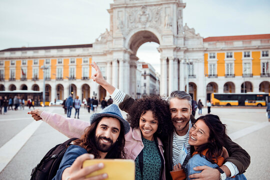 Happy friends taking selfie at arco da rua augusta in lisbon