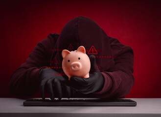 Financial hacking concept with masked hacker stealing piggy bank and warning symbols. Represents...