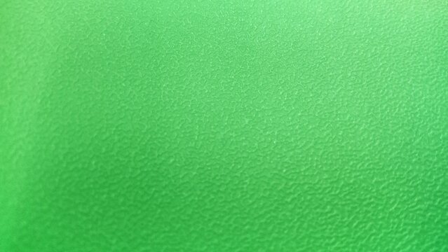 Green plastic textured surface background close up
