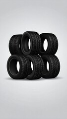 Stack of seven black vehicle tires with a dark tread pattern against a gray background