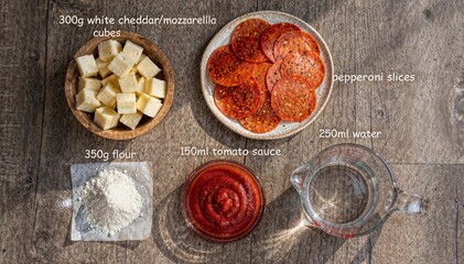 Fototapeta premium Homemade Pepperoni Pizza Ingredients with Recipe Measurements Flat Lay