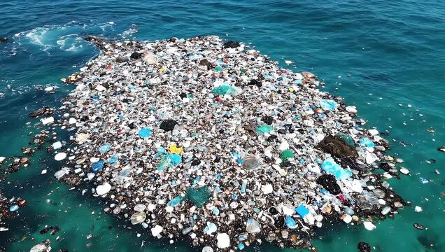 Massive floating patch of multicolored plastic waste accumulating on the deep blue ocean surface