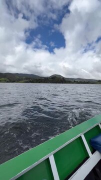 Sailing on La Cocha Lagoon in a small boat. Nari&ntilde;o, Colombia