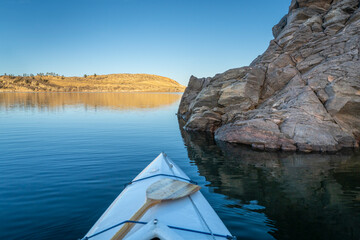Horsetooth Reservoir at foothills of Rocky Mountains in northern Colorado - POV from expedtion canoe in warm winter scenery