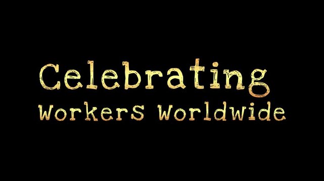 Animated golden text declaring celebrating workers worldwide floats above vibrant colorful fireworks exploding against a dark night sky background for labor day.