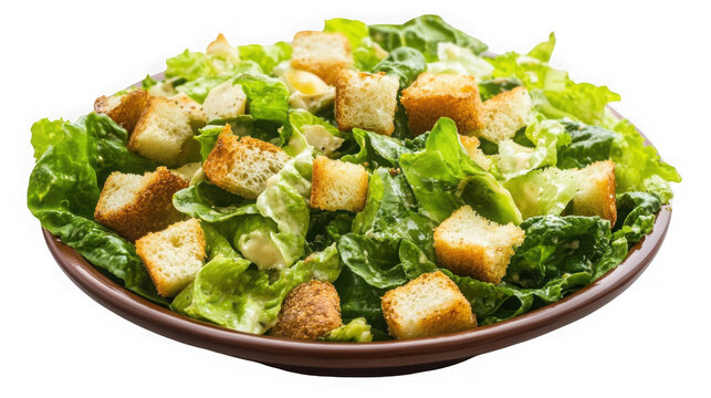 Freshly prepared classic caesar salad tossed with creamy dressing and crunchy golden brown croutons served in a bowl on transparent background