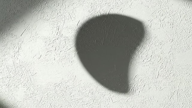 Close up of a textured surface with a shadow of a curved object creating an abstract pattern for design projects