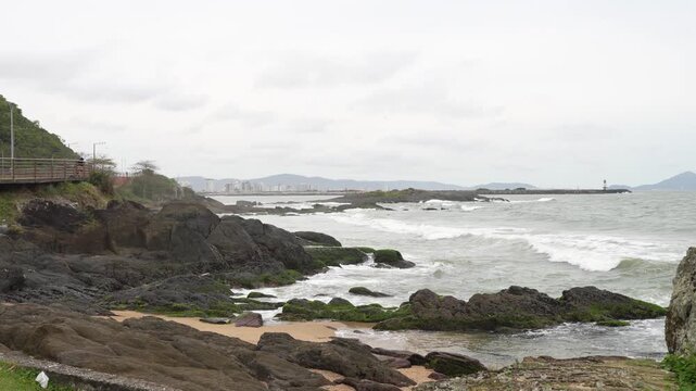Rocky coastline with waves crashing in Atalaia, Itajai, Brazil