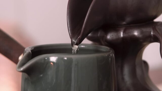 Tea pouring. Aroma beverage. Filling cup with drinking refreshing gaba liquid healthy atmosphere peaceful lifestyle burning incense.