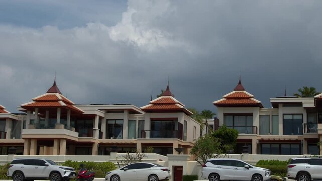 Luxury Thai Resort Villas with Traditional Roofs Under Stormy Skies