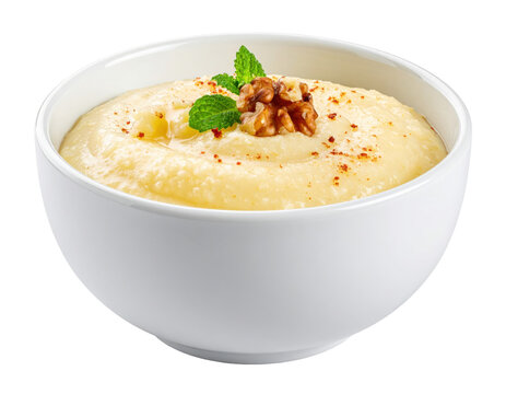 Creamy Semolina Porridge Garnished with Walnut Halves and Fresh Mint Sprigs in White Bowl