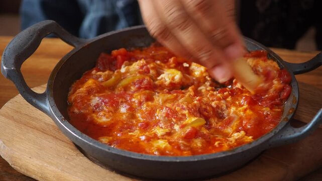 closeup of turkish menemen in a cast iron pan 