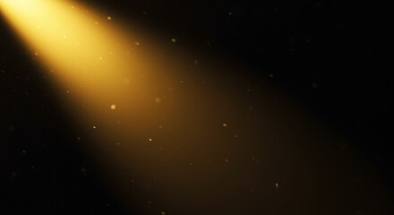 Obraz premium A bright yellow light beam shining through a dark space with floating dust particles.