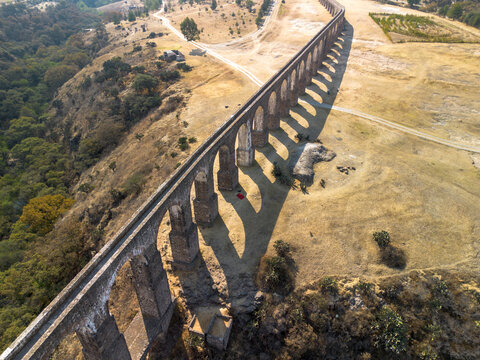 Colonial aqueduct in Mexico with sunset shadows.