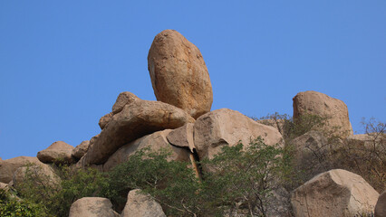 Big round granite boulder standing leaning on its tip. Sanapur, village near Hampi, India. © u.perreten