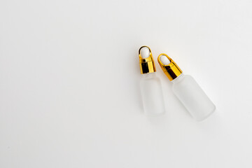 Minimal Frosted Glass Serum Bottle with Gold Dropper Cap on White Background