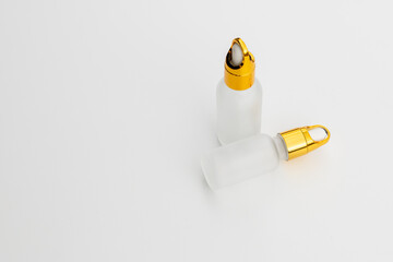Minimal Frosted Glass Serum Bottle with Gold Dropper Cap on White Background