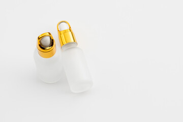 Minimal Frosted Glass Serum Bottle with Gold Dropper Cap on White Background