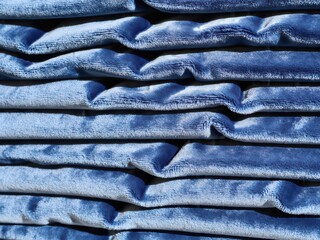 Folded Blue Velveteen Fabric Stack Close-Up