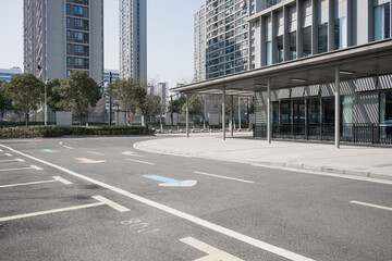 Urban street beside modern buildings with empty asphalt road surface