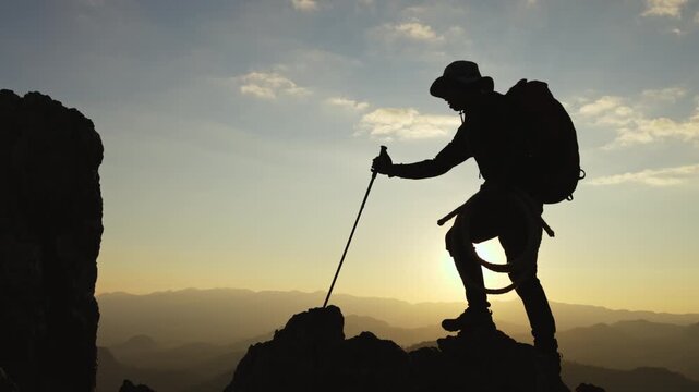 Man hiker on a top of a mountain, hiking in mountains