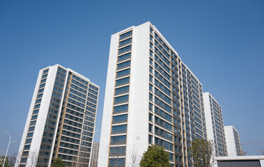Modern high-rise residential buildings standing under a clear blue sky