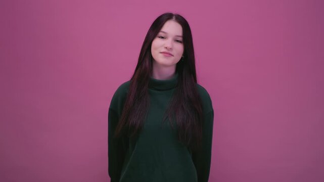 Face portrait: attractive young teenage girl with black hair. Generation Z. Confident caucasian teen schoolgirl woman posing on background in studio. Female kid looking at camera.