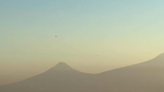 NATO fighter jet over a city near Mount Ararat and Yerevan, Two fighter jets in the sky perform a dangerous maneuver, pilots are preparing, dangerous turns. War. Middle East. 10.03.2025. High quality 