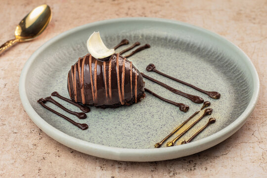Chocolate Mousse Dome is an elegant gourmet dessert featuring a smooth, velvety chocolate mousse shaped into a perfect dome and finished with a glossy mirror glaze. Rich cocoa flavor with a light, air