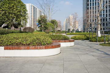 Urban park green belt with modern high-rise buildings and landscaped walkways © zhu difeng