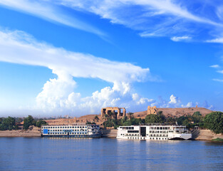 Obraz premium View from cruise ship on Nile river and Kom Ombo Temple, Egypt, Africa. Luxury Nile Cruise. Summer vacation, relaxing on cruise ship. Famous tourist attraction. Topic of travel, trip, cruises and tour