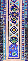Vertical background with detail of ancient mosaic walls with floral and geometric ornament. Traditional tile decoration on wall, Samarkand, Uzbekistan