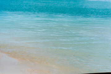 Obraz premium Blue sea white beach turquoise ocean wave coastal in tropical paradise landscape. Beautiful scene seascape marine coastline destinations. Tropical beautiful blue ocean lagoon lake travel summer time.