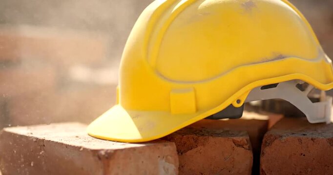 Yellow Hard Hat on Bricks Construction Site.