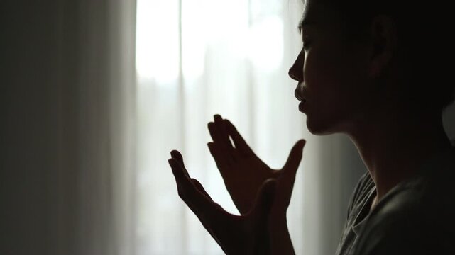  Silhouette of Person hands open palm up worship God helping repent catholic easter lent mind pray Christian religion.  prayer woman worship God in the morning with sunrise.