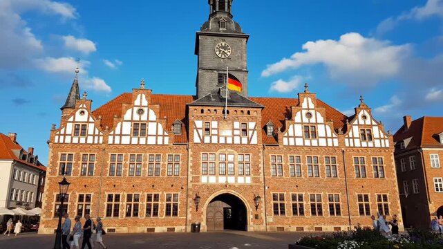 Ornate building with a clock tower and German flag