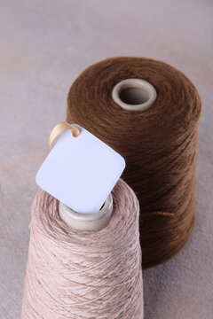 Wool yarn on bobbins. The tag is on babin. Fine yarn made of pure wool. Handmade work. Concept of hobbies and handicrafts.