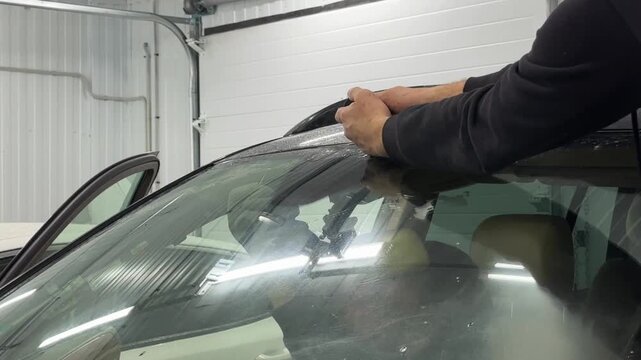cutting and removing the windshield of a car