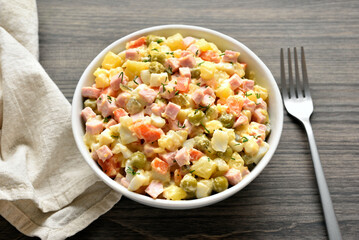 Olivier salad from boiled vegetables, dressed with mayonnaise sauce
