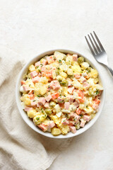 Olivier salad from boiled vegetables, dressed with mayonnaise sauce