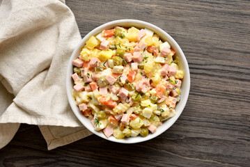 Olivier salad from boiled vegetables, dressed with mayonnaise sauce