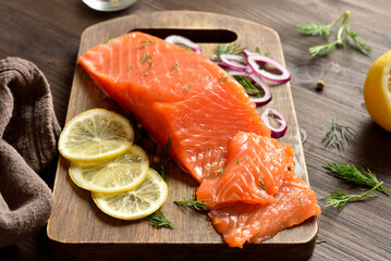 Fresh salted salmon with spices on cutting board